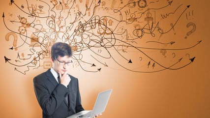 man on laptop, thinking, with arrows and cables coming out of his head