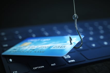 credit card caught on fishing hook to illustrate email phishing scam